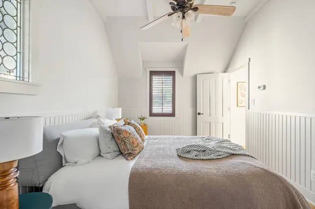 a bedroom with a bed and a chandelier