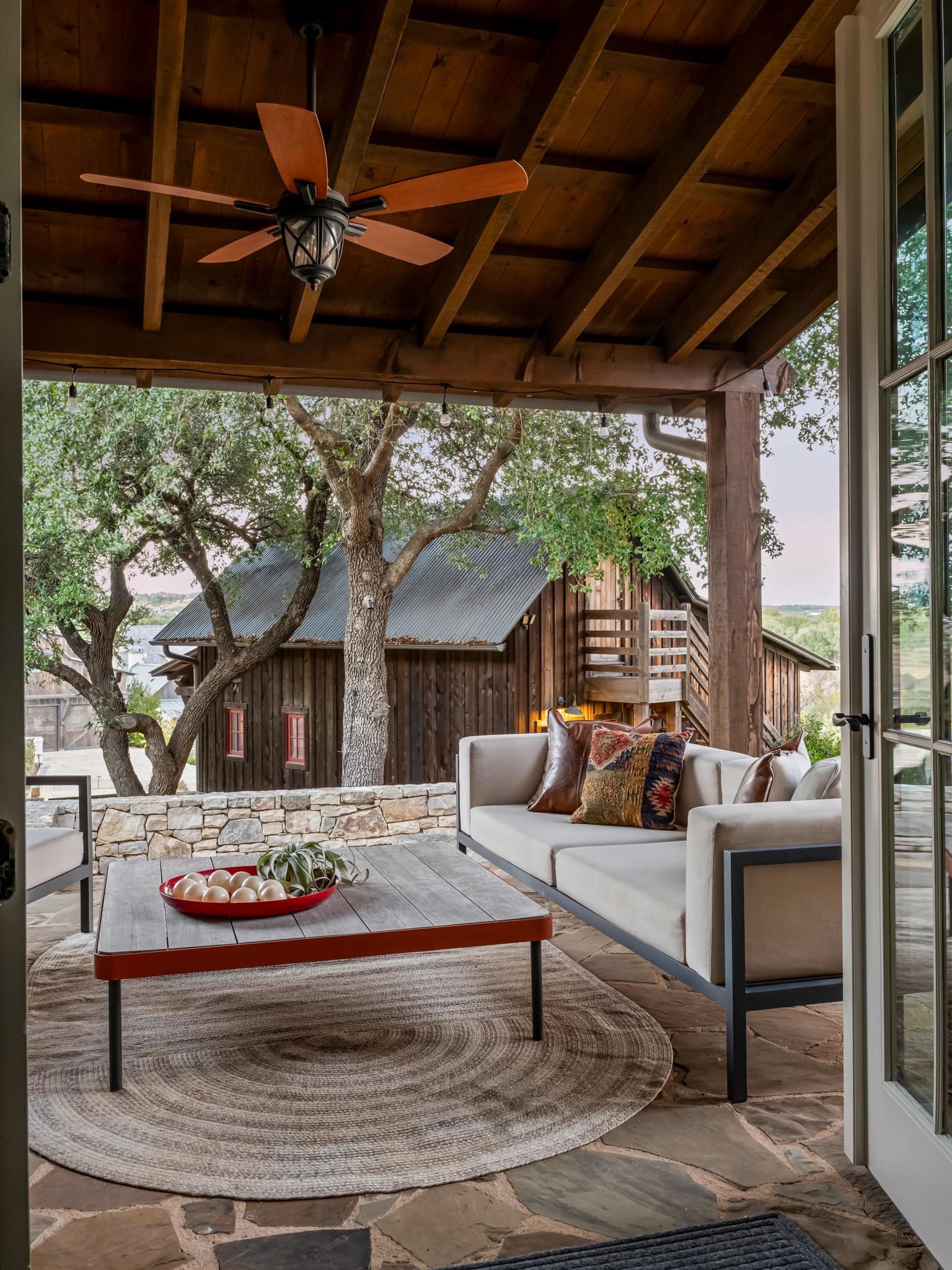 65 Riviera Cove Fredericksburg, TX 78624 - Photo 16 of 26 a outdoor space with the couches and dining table with the view of potted plants