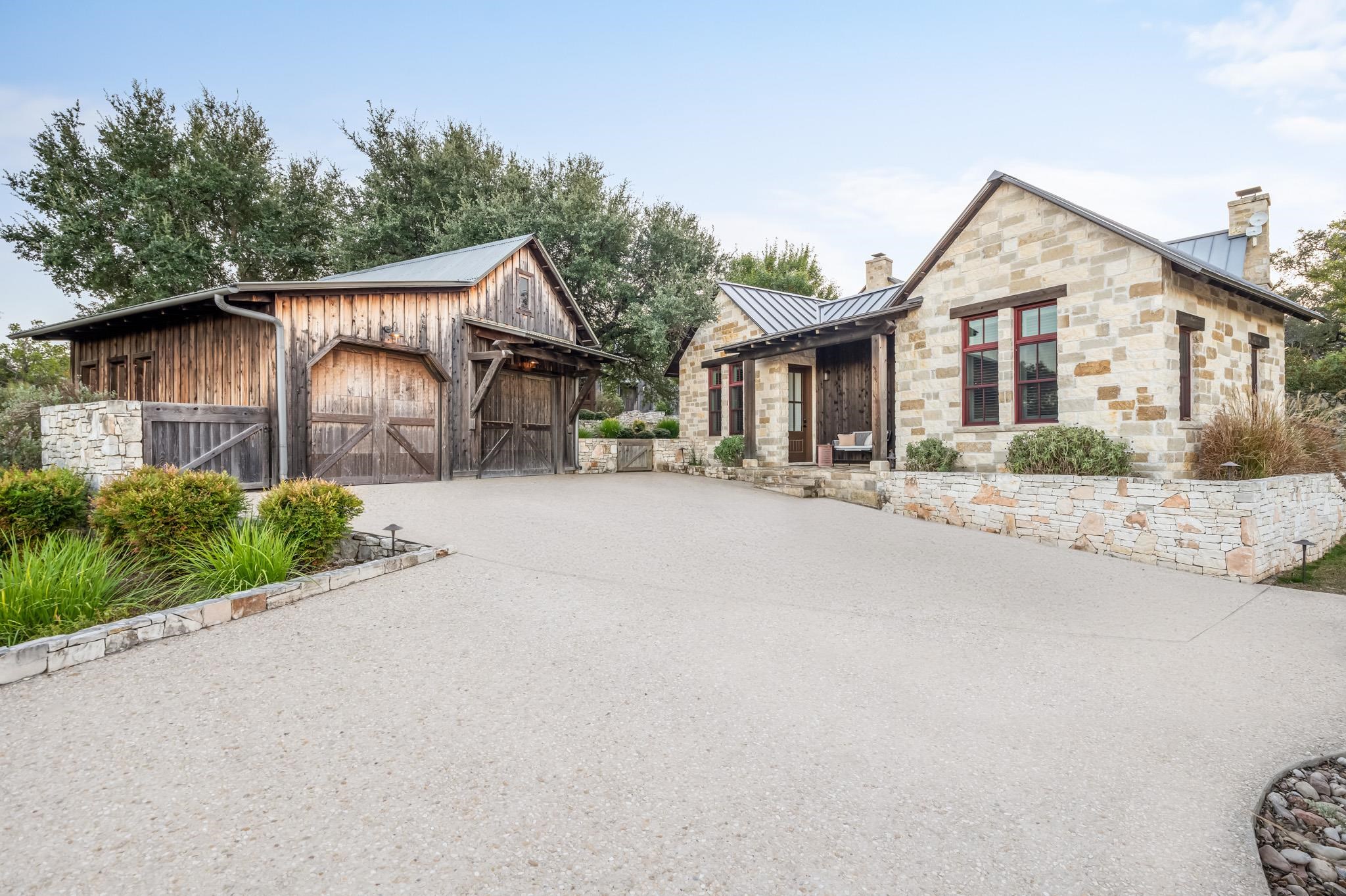 65 Riviera Cove Fredericksburg, TX 78624 - Photo 18 of 26 a front view of a house with a yard and potted plants