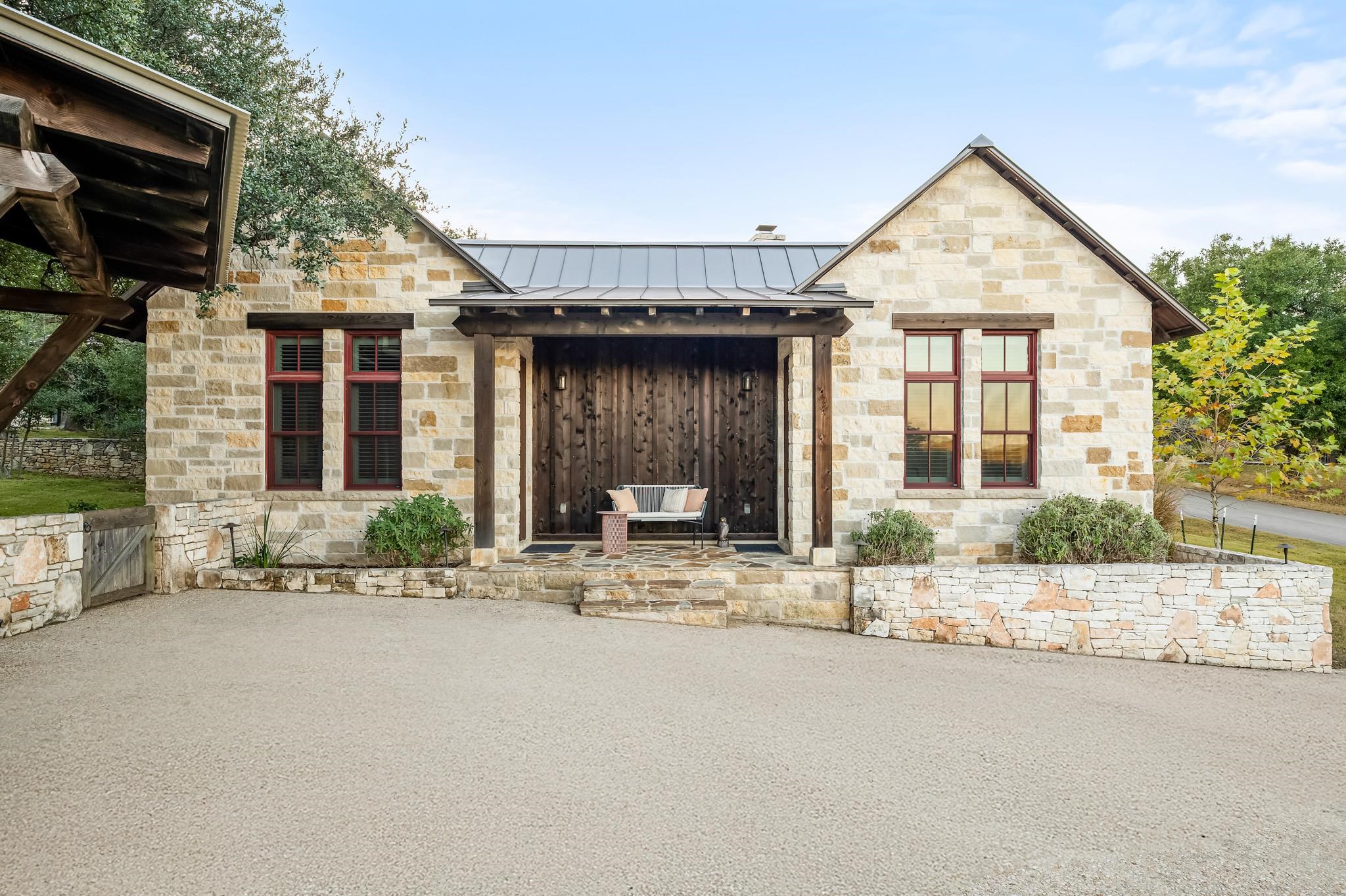 65 Riviera Cove Fredericksburg, TX 78624 - Photo 19 of 26 a front view of a house with a garden and yard