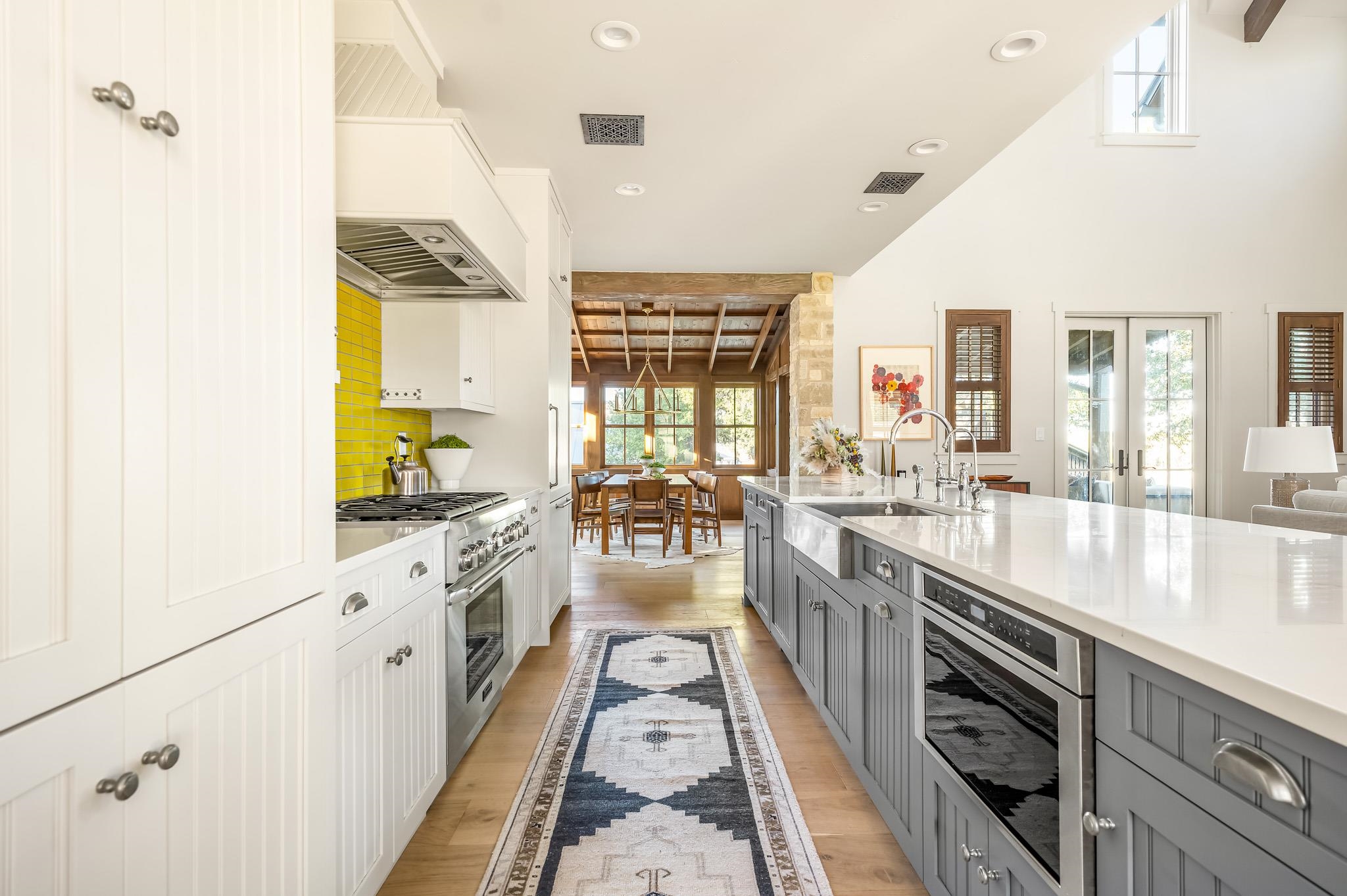 65 Riviera Cove Fredericksburg, TX 78624 - Photo 5 of 26 a large kitchen with stainless steel appliances granite countertop a lot of counter space and wooden floors