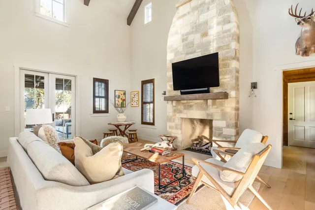 a living room with fireplace furniture and a flat screen tv