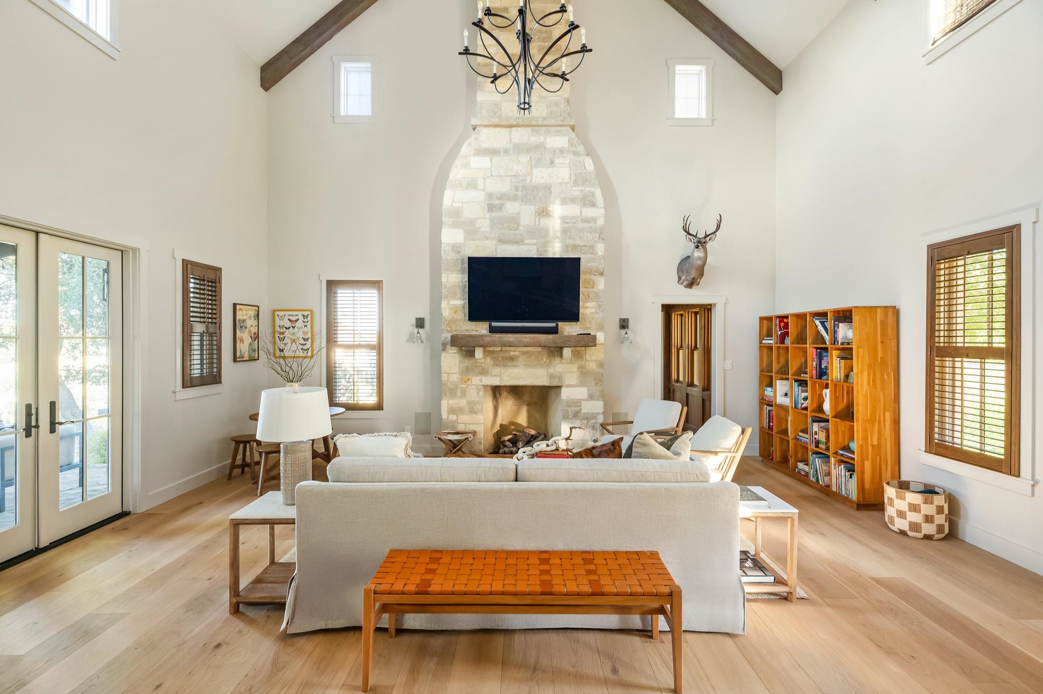 65 Riviera Cove Fredericksburg, TX 78624 - Photo 9 of 26 a living room with furniture a fireplace and flat screen tv