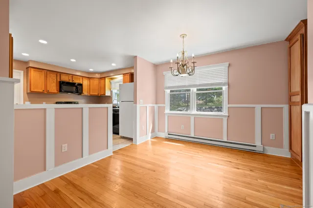 a view of a kitchen with a sink and dishwasher kitchen view with wooden floor and windows