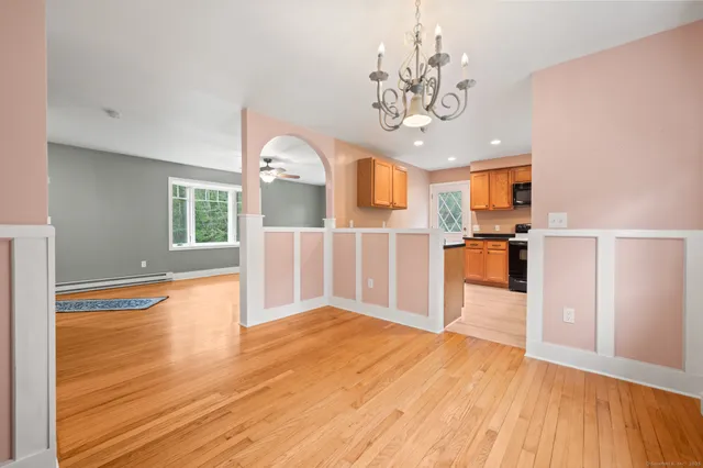 a view of a kitchen with wooden floor and a window