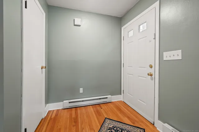 a view of a hallway with wooden floor