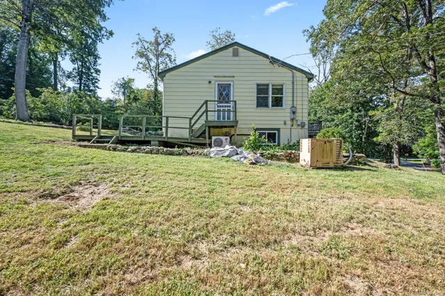a view of a house with backyard and sitting area