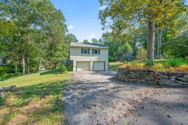 a view of a house with a yard and hanging chair