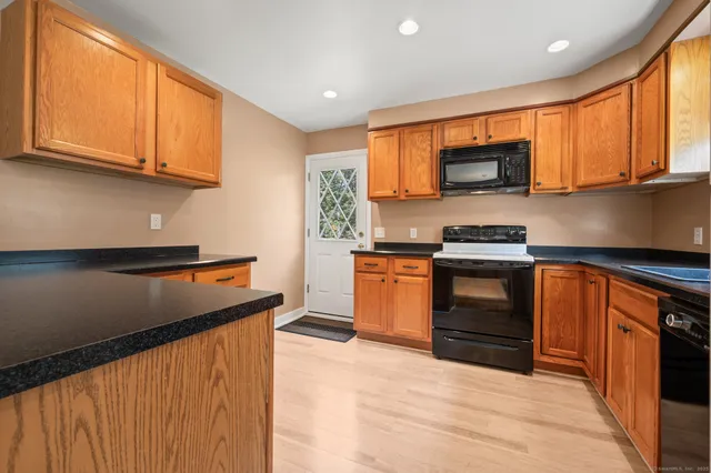 a kitchen with stainless steel appliances granite countertop a stove top oven a sink dishwasher and a microwave oven on the blue kitchen countertops
