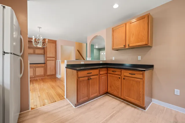 a kitchen with stainless steel appliances granite countertop a refrigerator and a sink