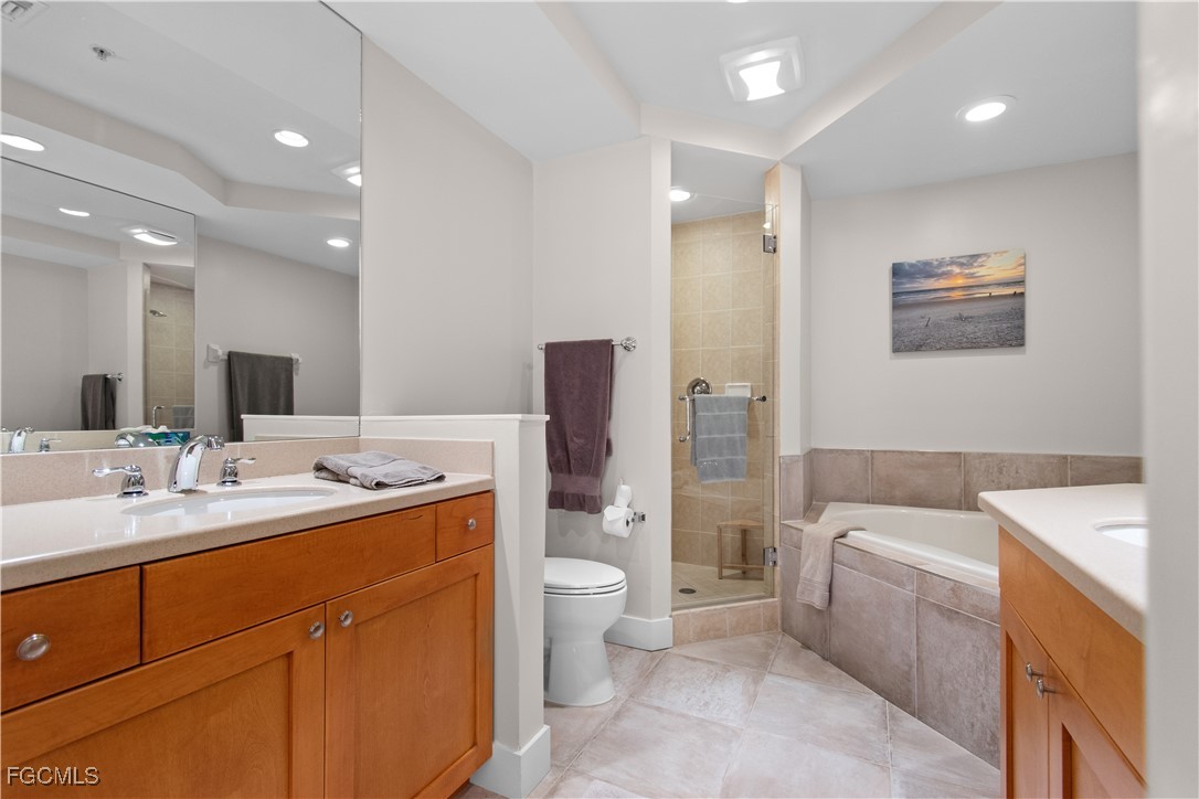 2110 West First Street, Unit 101 Fort Myers, FL 33901 - Photo 11 of 38 a bathroom with a double vanity sink toilet mirror and bathtub