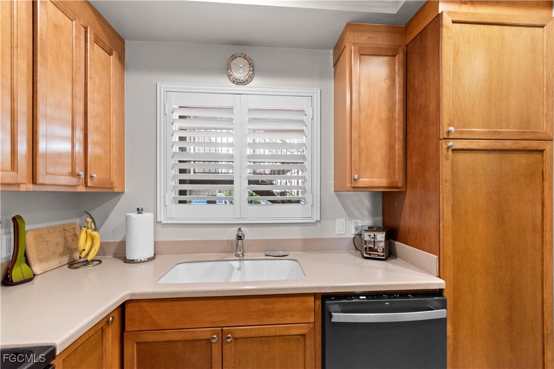 2110 West First Street, Unit 101 Fort Myers, FL 33901 - Photo 12 of 34 a kitchen with stainless steel appliances a sink and a window