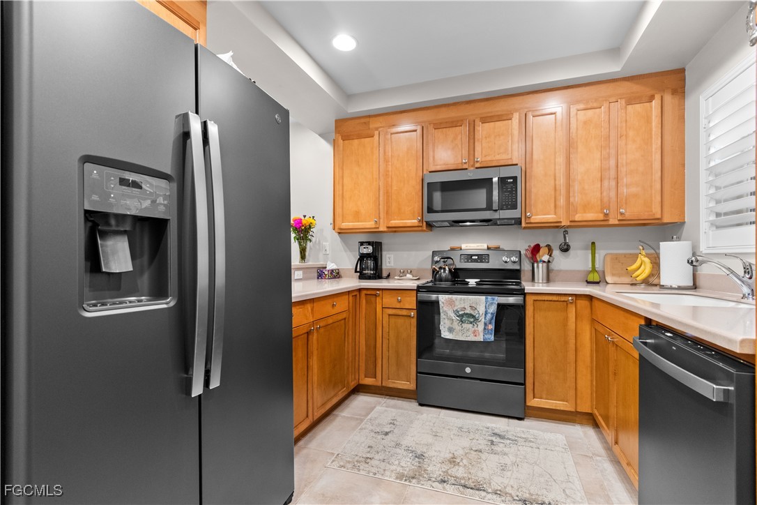 2110 West First Street, Unit 101 Fort Myers, FL 33901 - Photo 13 of 38 a kitchen with stainless steel appliances granite countertop a refrigerator stove and sink