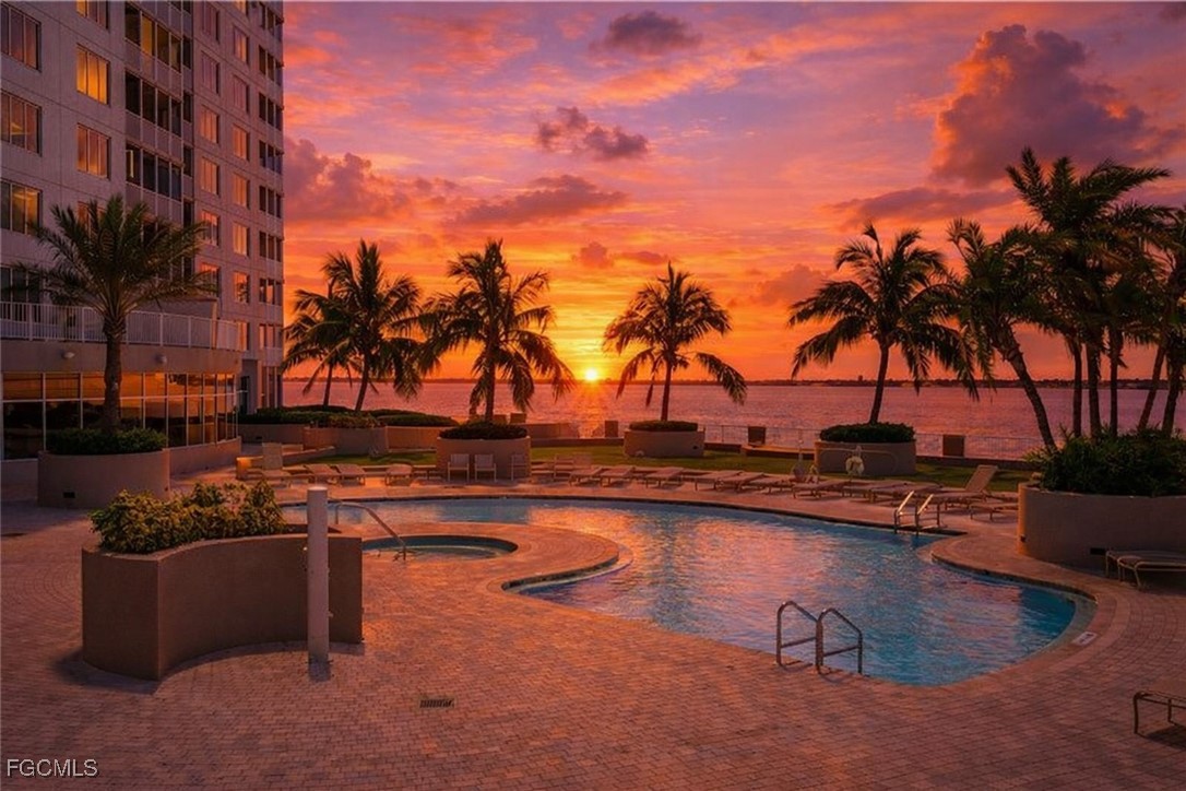 2110 West First Street, Unit 101 Fort Myers, FL 33901 - Photo 27 of 38 a view of a swimming pool with a table and chairs