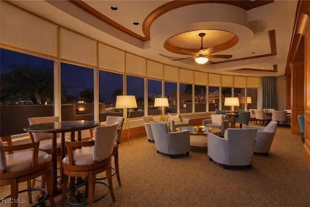 a dining room with wooden floor and chandelier