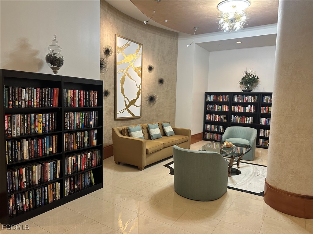 2110 West First Street, Unit 101 Fort Myers, FL 33901 - Photo 35 of 38 a living room with furniture a rug and a book shelf