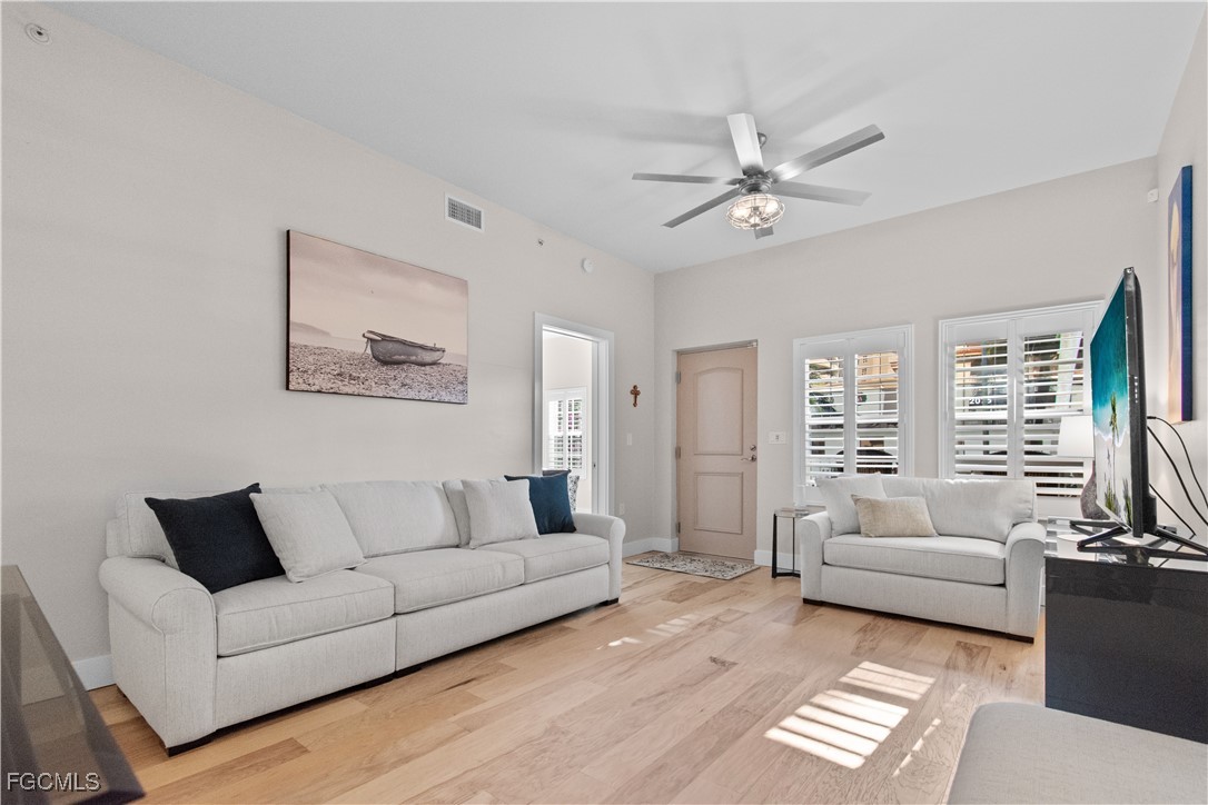 2110 West First Street, Unit 101 Fort Myers, FL 33901 - Photo 4 of 34 a living room with furniture and a large window
