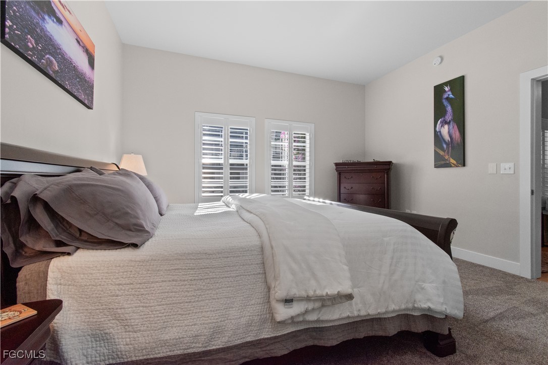 2110 West First Street, Unit 101 Fort Myers, FL 33901 - Photo 6 of 34 a bedroom with a bed and a window