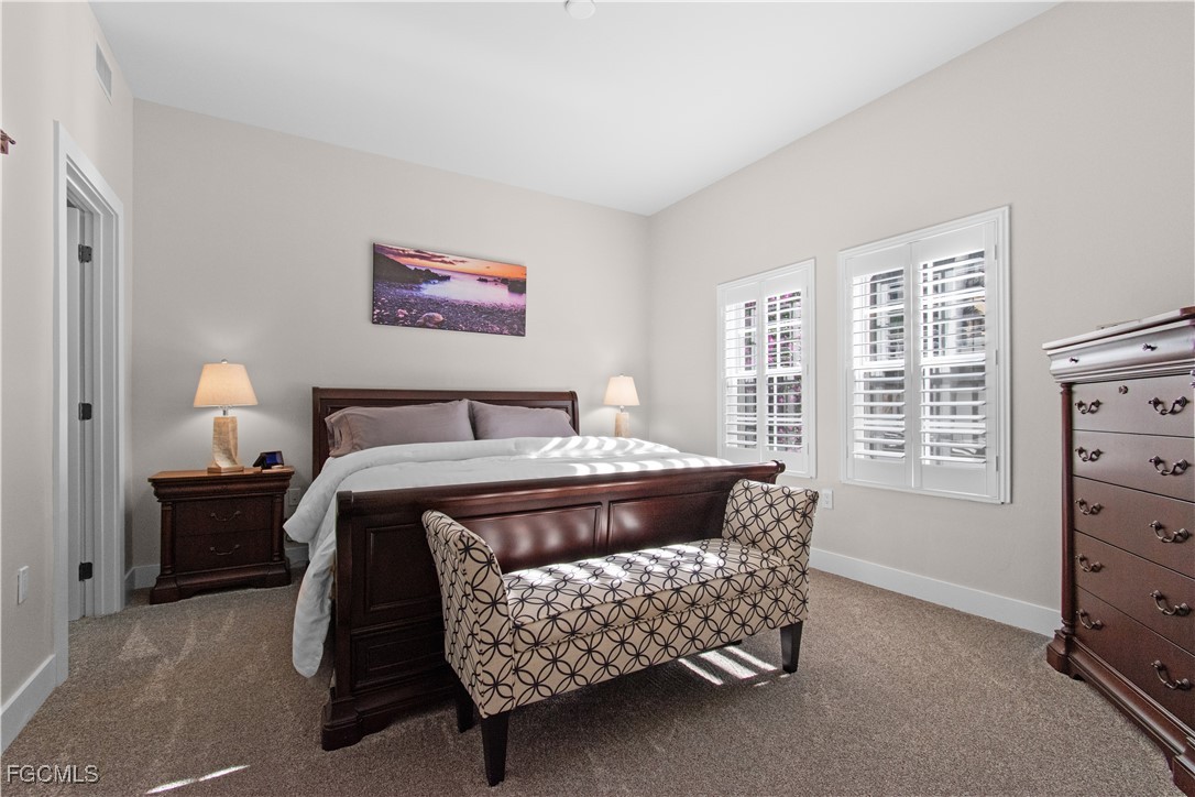2110 West First Street, Unit 101 Fort Myers, FL 33901 - Photo 7 of 38 a bedroom with a bed and a dresser