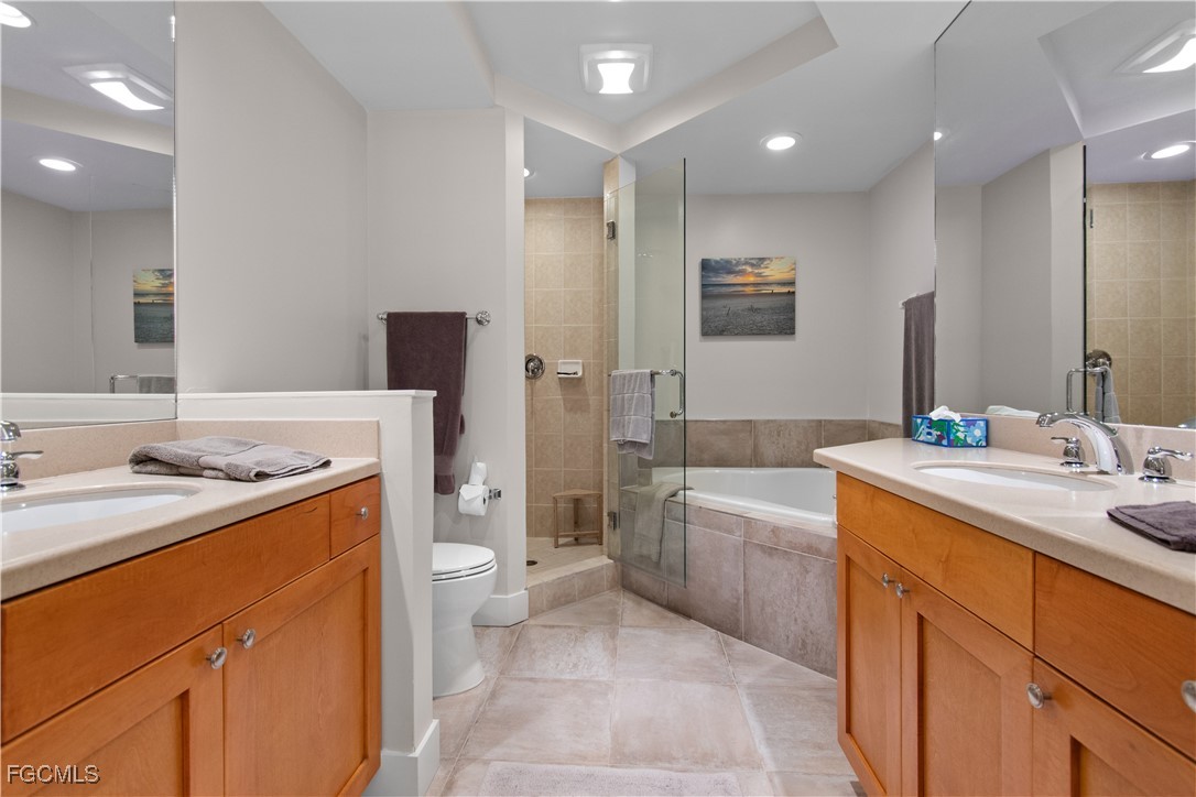 2110 West First Street, Unit 101 Fort Myers, FL 33901 - Photo 7 of 34 a bathroom with a sink a toilet and shower