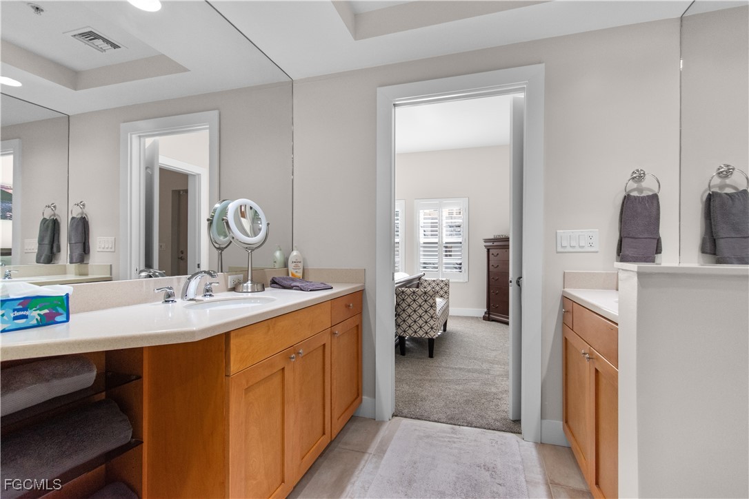 2110 West First Street, Unit 101 Fort Myers, FL 33901 - Photo 10 of 38 a en suite bathroom with a sink double vanity and a mirror