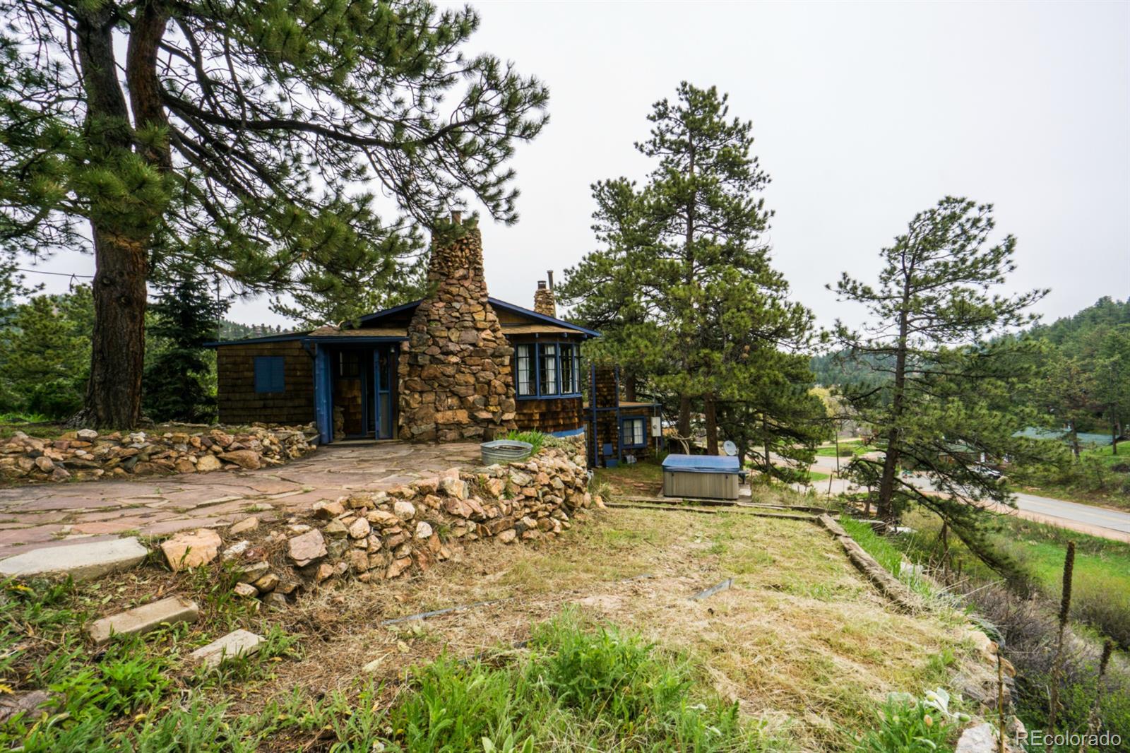 a view of a house with backyard and sitting area