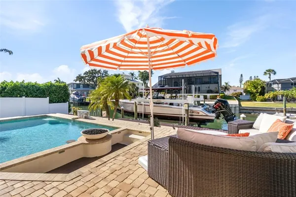 a view of a swimming pool with outdoor seating