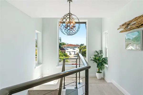 a view of a balcony with wooden floor and outdoor seating