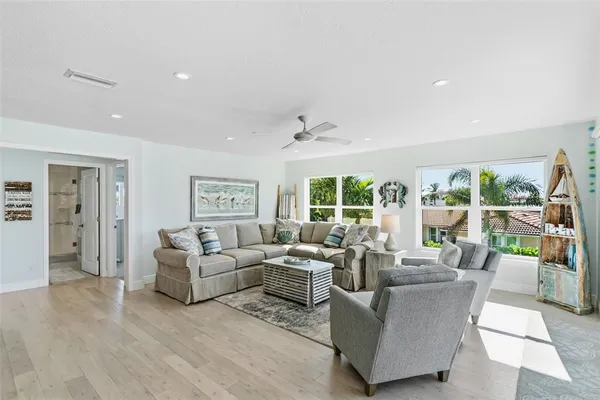 a backyard of a house with wooden floor a fire pit and chairs