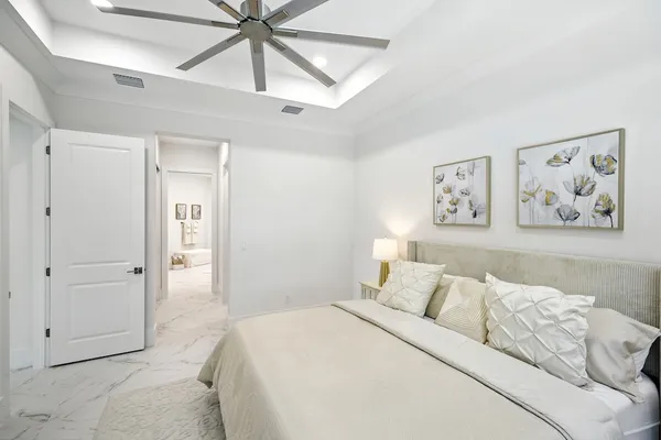 a bedroom with a bed and a painting on the wall