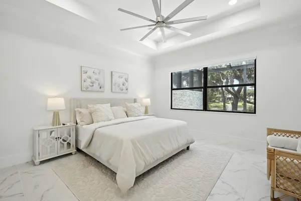 a bedroom with a large bed and a window
