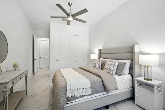 a bedroom with a bed and a chandelier