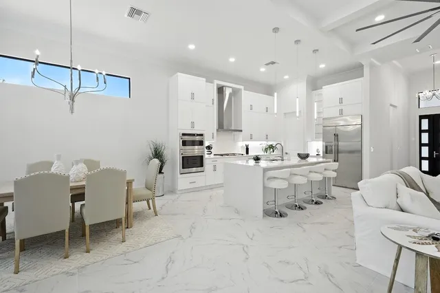 a living room with furniture and kitchen view