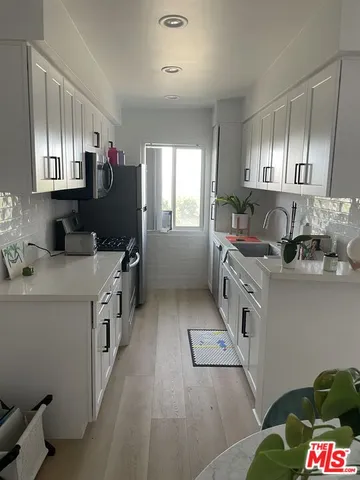 a kitchen that has a sink and a stove in it