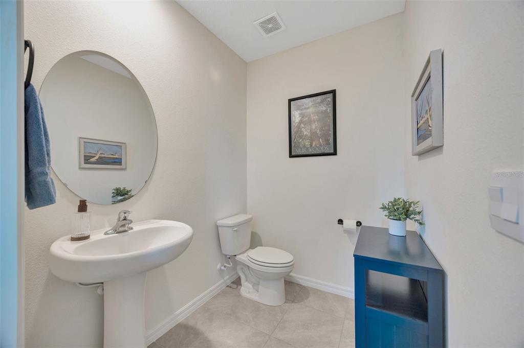 5758 Hollingworth Trail Wesley Chapel, FL 33545 - Photo 12 of 33 a bathroom with a sink toilet and a mirror