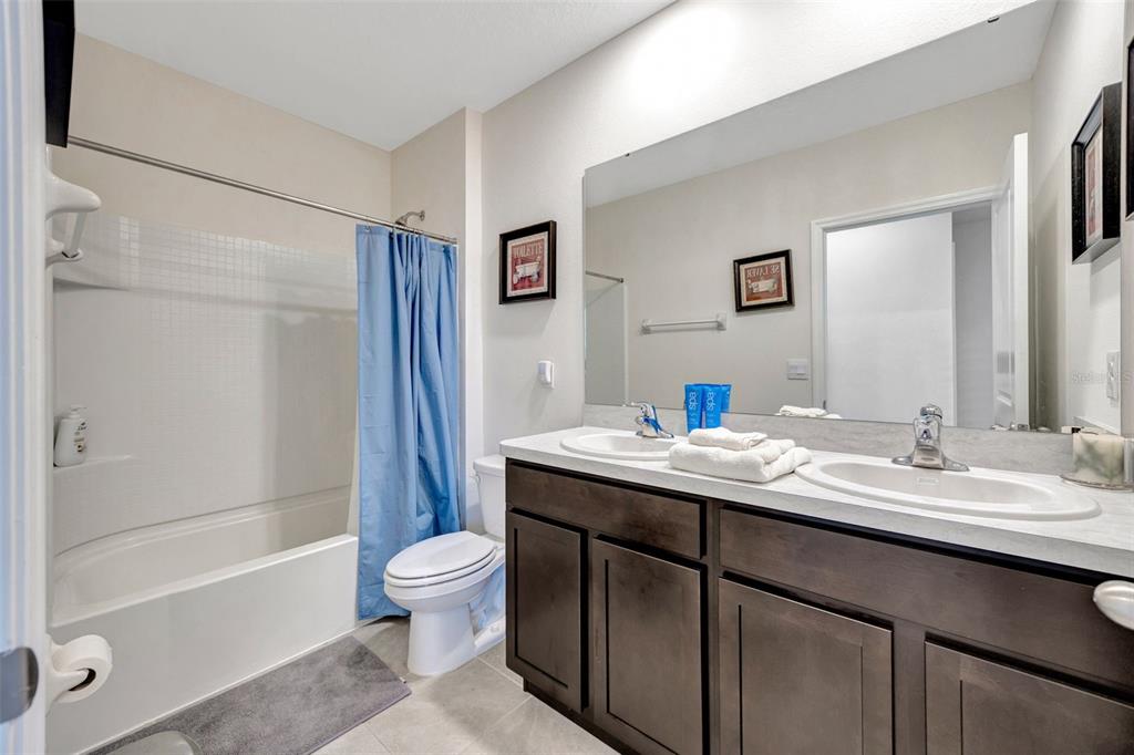 5758 Hollingworth Trail Wesley Chapel, FL 33545 - Photo 18 of 33 a bathroom with a granite countertop sink toilet and shower