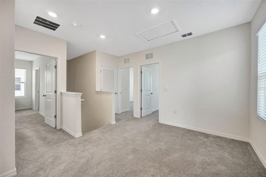 5758 Hollingworth Trail Wesley Chapel, FL 33545 - Photo 20 of 33 an empty room with closet and mirrors