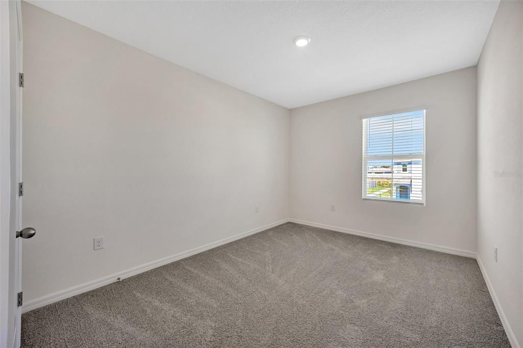5758 Hollingworth Trail Wesley Chapel, FL 33545 - Photo 21 of 33 an empty room with a window