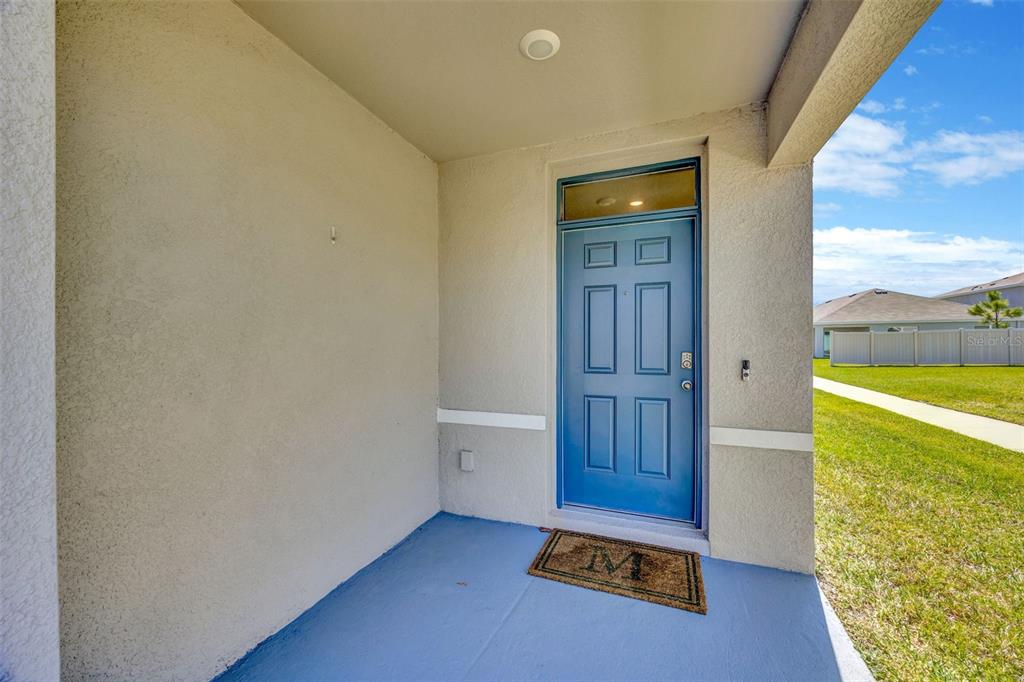 5758 Hollingworth Trail Wesley Chapel, FL 33545 - Photo 3 of 33 a view of an empty room and a kitchen