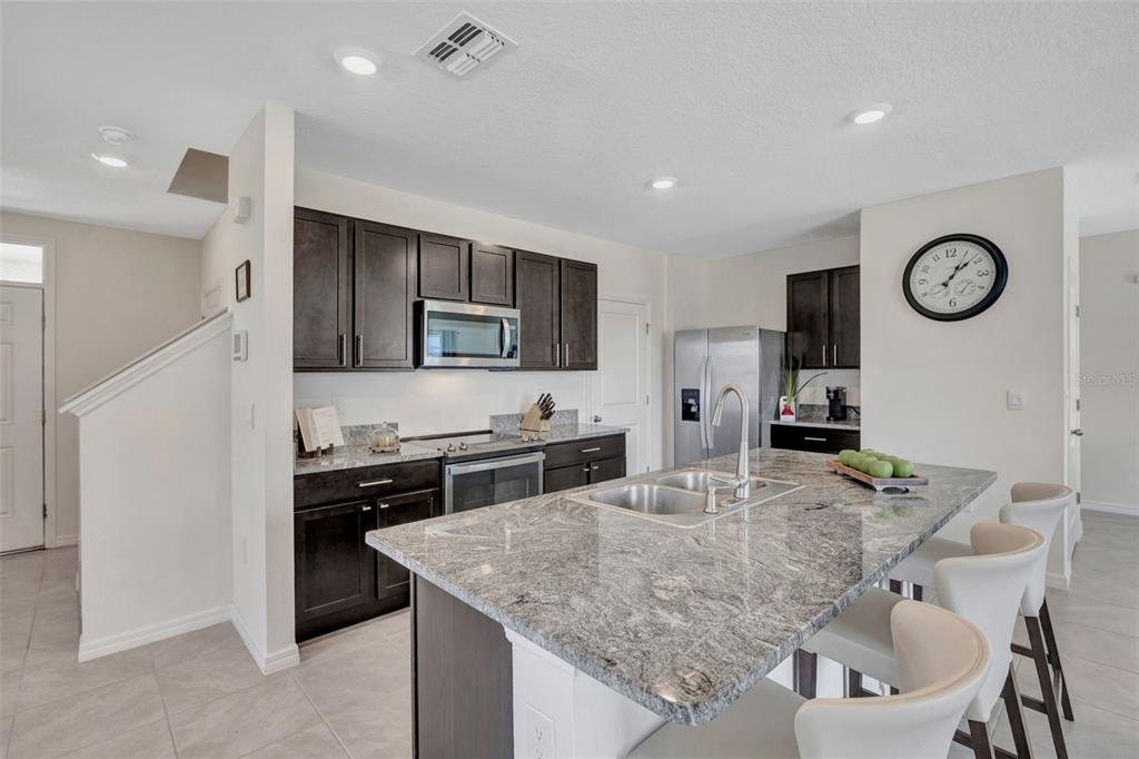 5758 Hollingworth Trail Wesley Chapel, FL 33545 - Photo 6 of 33 a kitchen with stainless steel appliances granite countertop a sink and cabinets