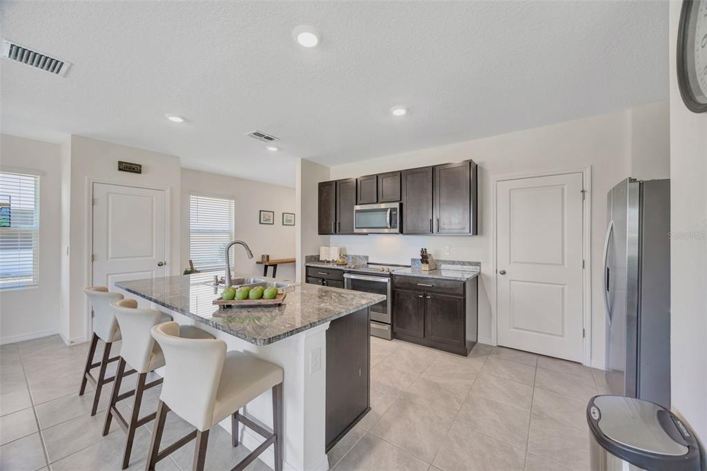 5758 Hollingworth Trail Wesley Chapel, FL 33545 - Photo 9 of 33 a kitchen with a sink stove and refrigerator