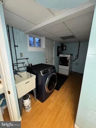 a utility room with sink dryer and washer