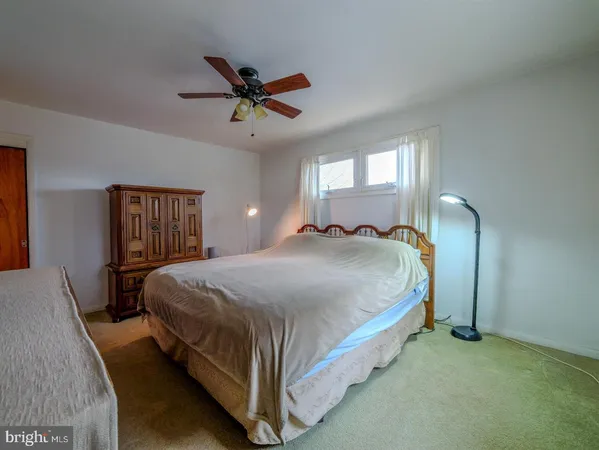 a bed sitting in a bedroom next to a window