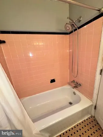 a bathroom with a bathtub and shower