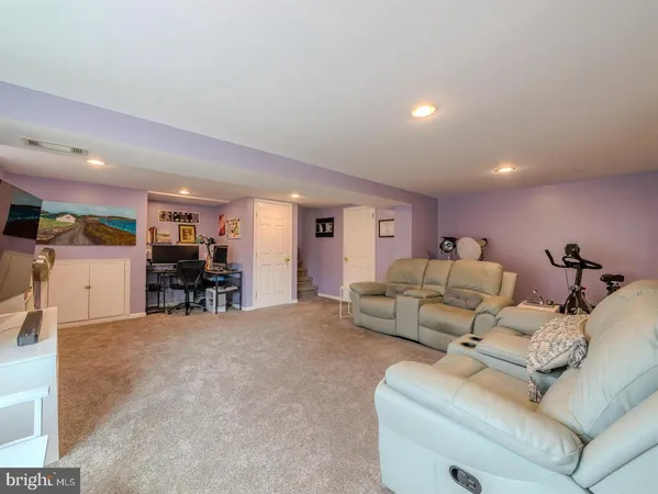 a living room with furniture and a dining table with kitchen view