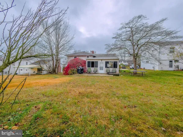 a view of swimming pool with outdoor seating and house in the background