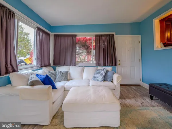 a living room with furniture and large window