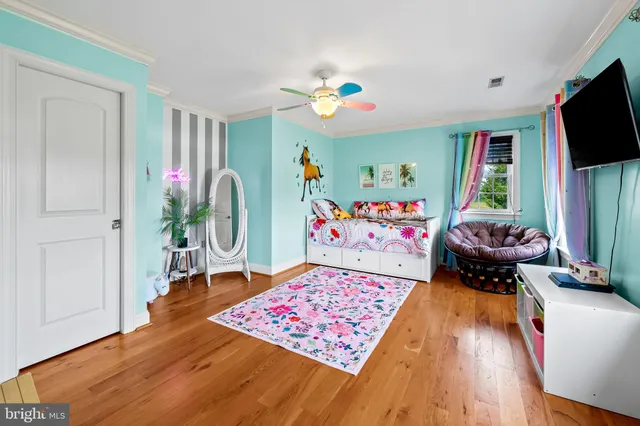 a room with furniture a flat screen tv and a window