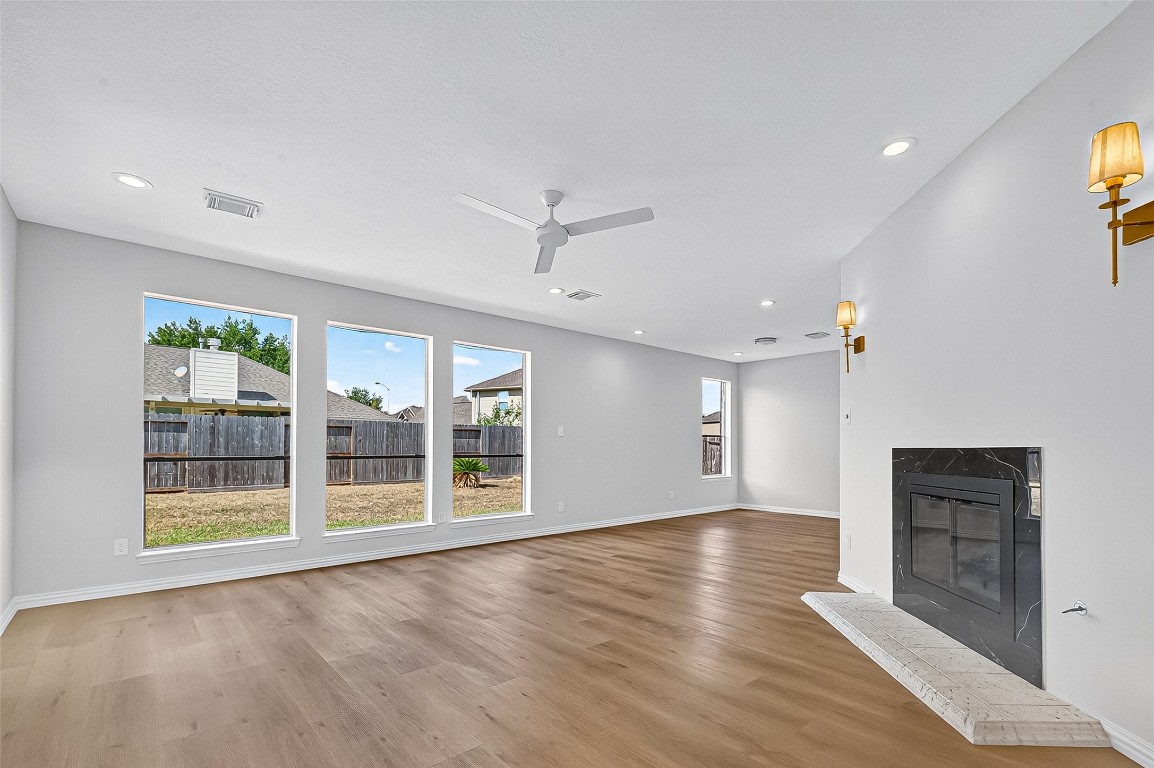 21310 Timber Pines Drive Spring, TX 77388 - Photo 12 of 49 an empty room with wooden floor and windows
