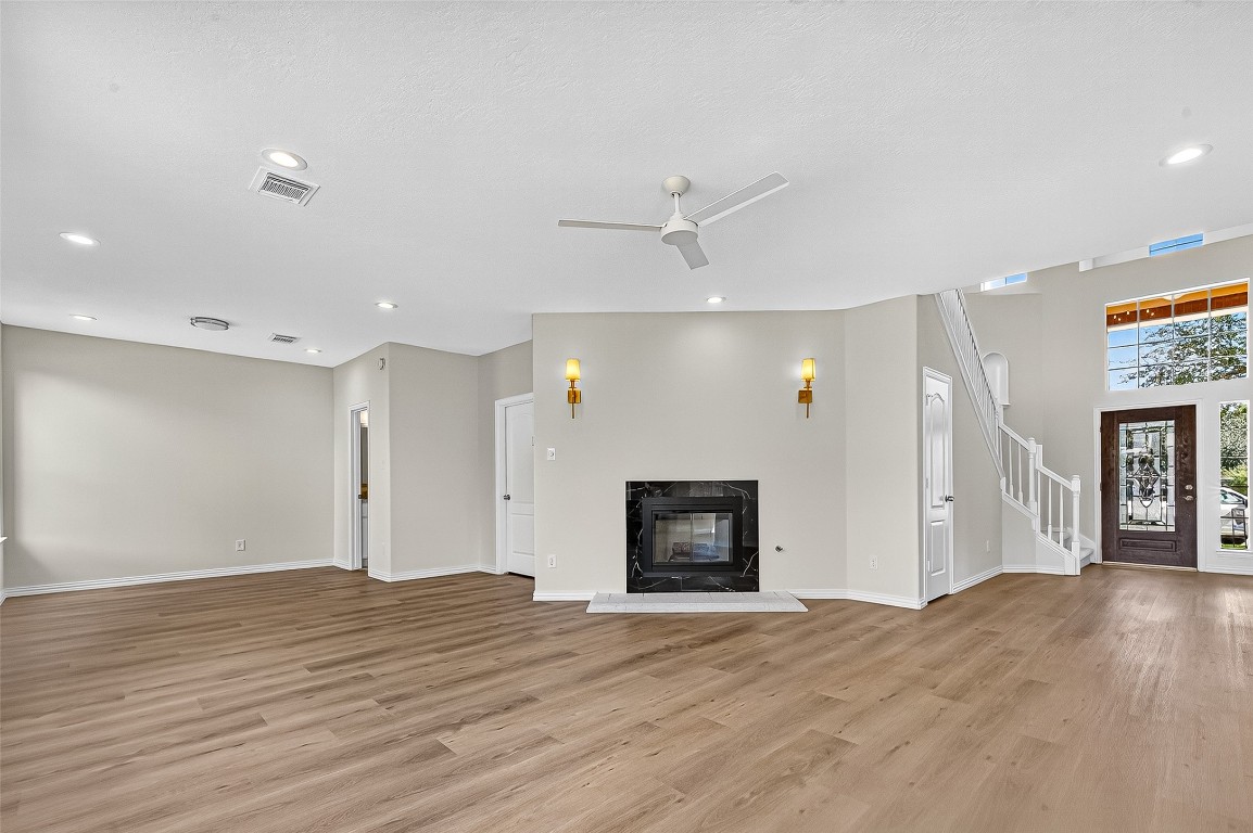21310 Timber Pines Drive Spring, TX 77388 - Photo 13 of 49 a view of a livingroom with a fireplace a ceiling fan and wooden floor